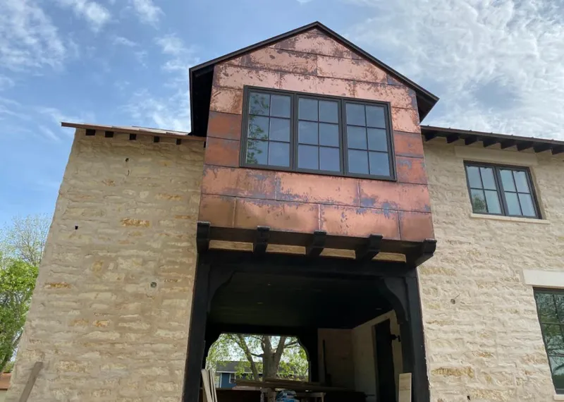 Copper metal panel facade on a stone building for Metal Roof Coating in Fernandina Beach