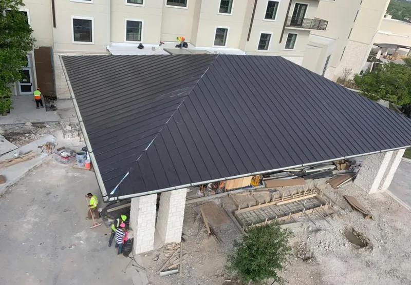 Metal roofing installation team working on a commercial building in Fernandina Beach