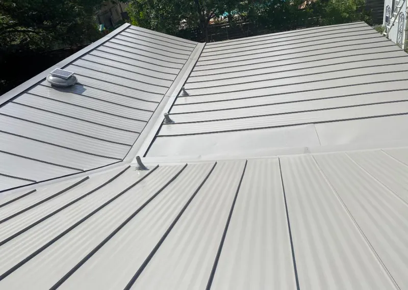 Solar attic fan installed on a metal roof for Roof Ventilation in Fernandina Beach
